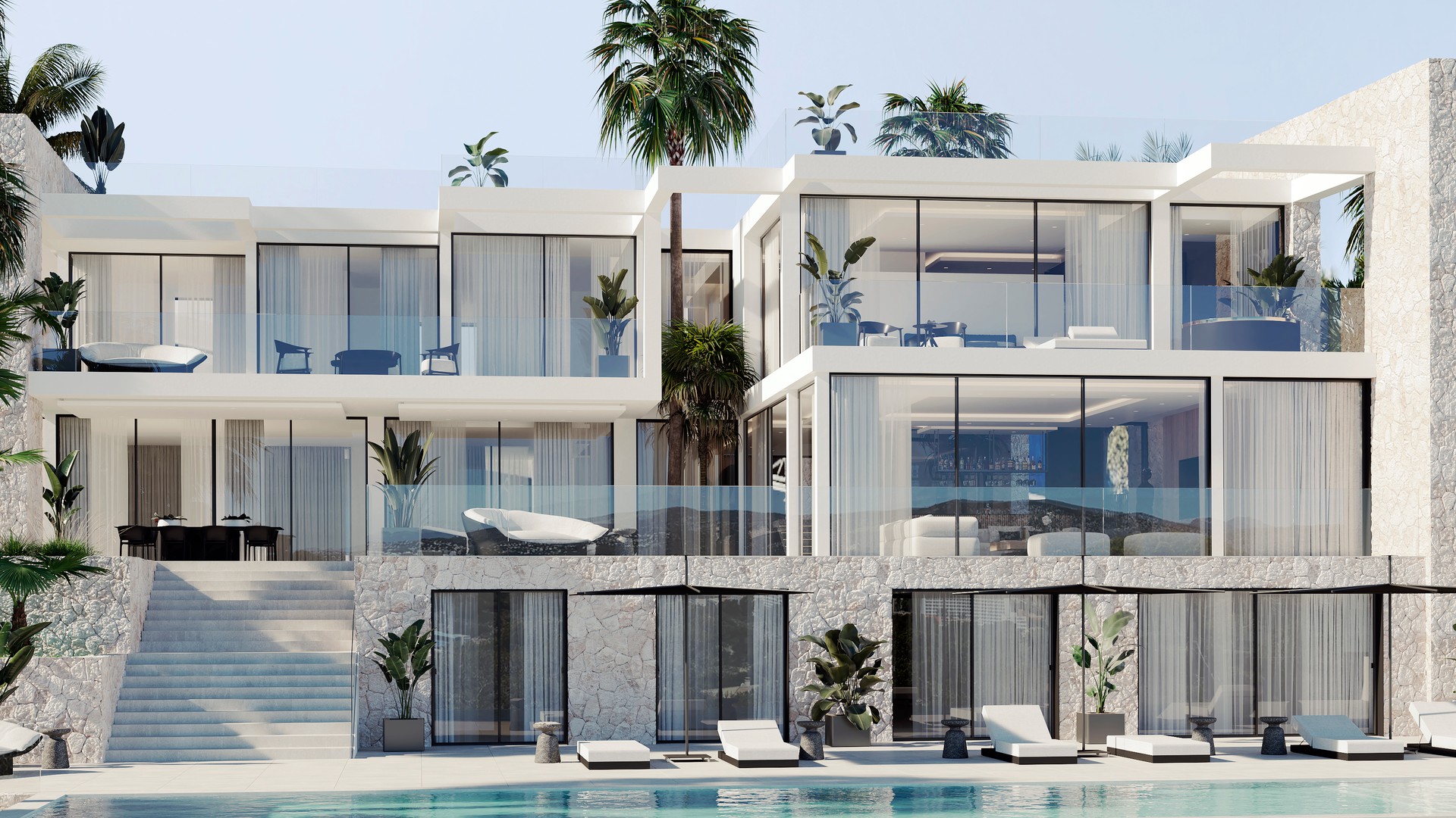 Exterior view of a multi-level contemporary villa with floor-to-ceiling glass windows, a stone-clad lower level, and an outdoor swimming pool with lounge chairs.