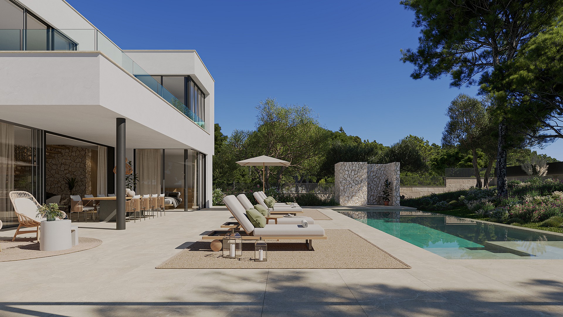 Wide angle view of a sun-drenched outdoor terrace with lounge chairs, a rectangular swimming pool, and stone wall features.