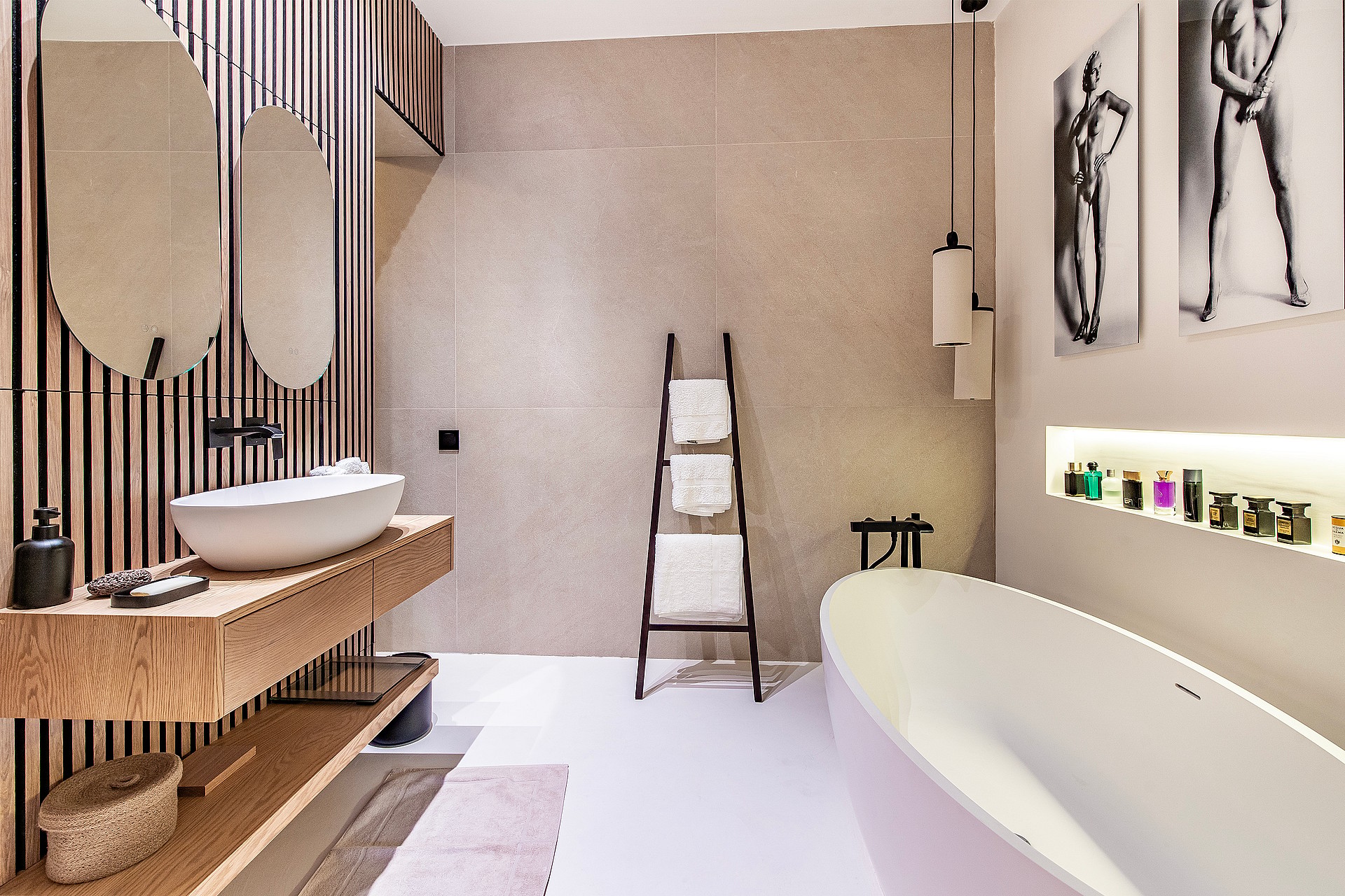 Modern bathroom featuring a white freestanding bathtub, wooden slatted feature wall, vessel sink, and minimal lighting.