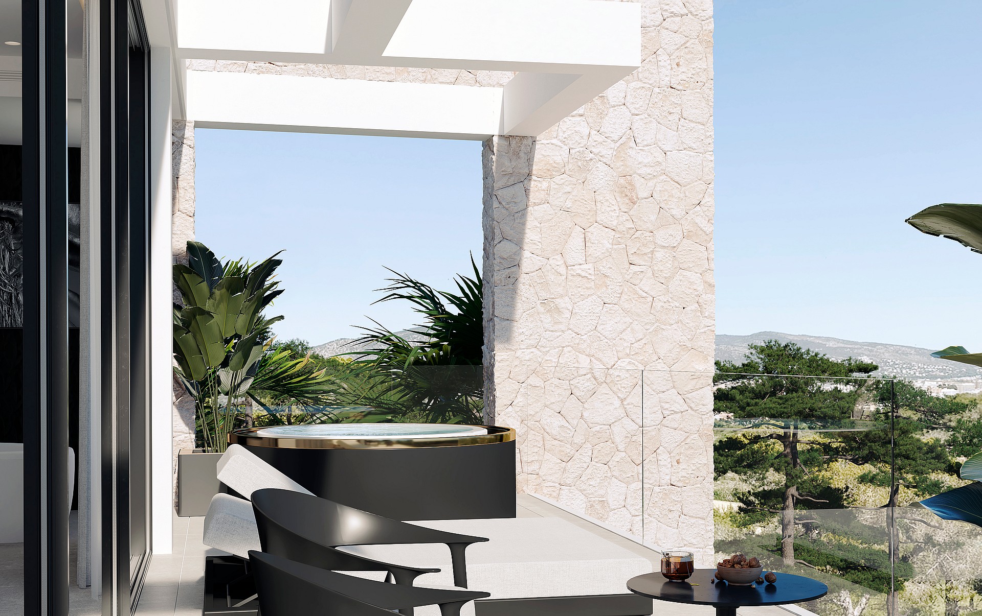 A covered terrace with a circular hot tub, black lounge chairs, stone walls, and green plants, opening to an outdoor view.