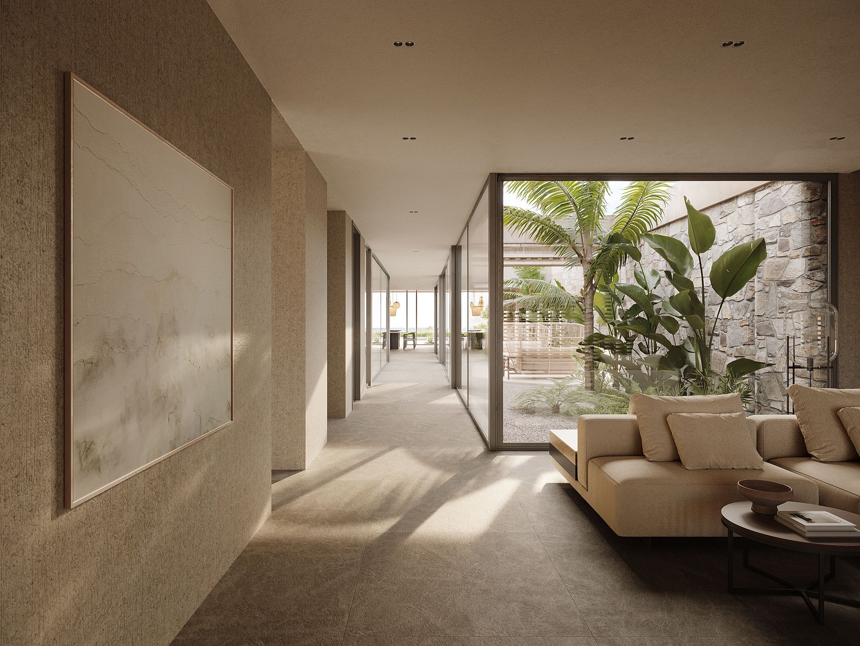 A long interior hallway with textured stone walls, modern sofa, and floor-to-ceiling glass windows overlooking a patio.