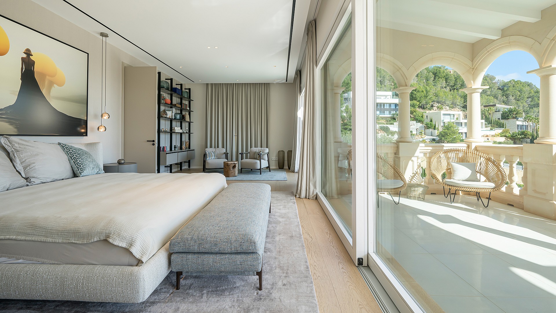 Master bedroom with a king-sized bed, soft grey fabrics, and open access to a private stone arched terrace in Son Vida.