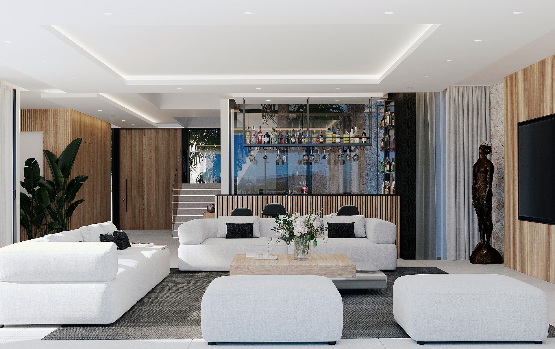 Spacious living room featuring white modular sofas, a central coffee table, and a dedicated bar area with glass shelving and wood-paneled walls.