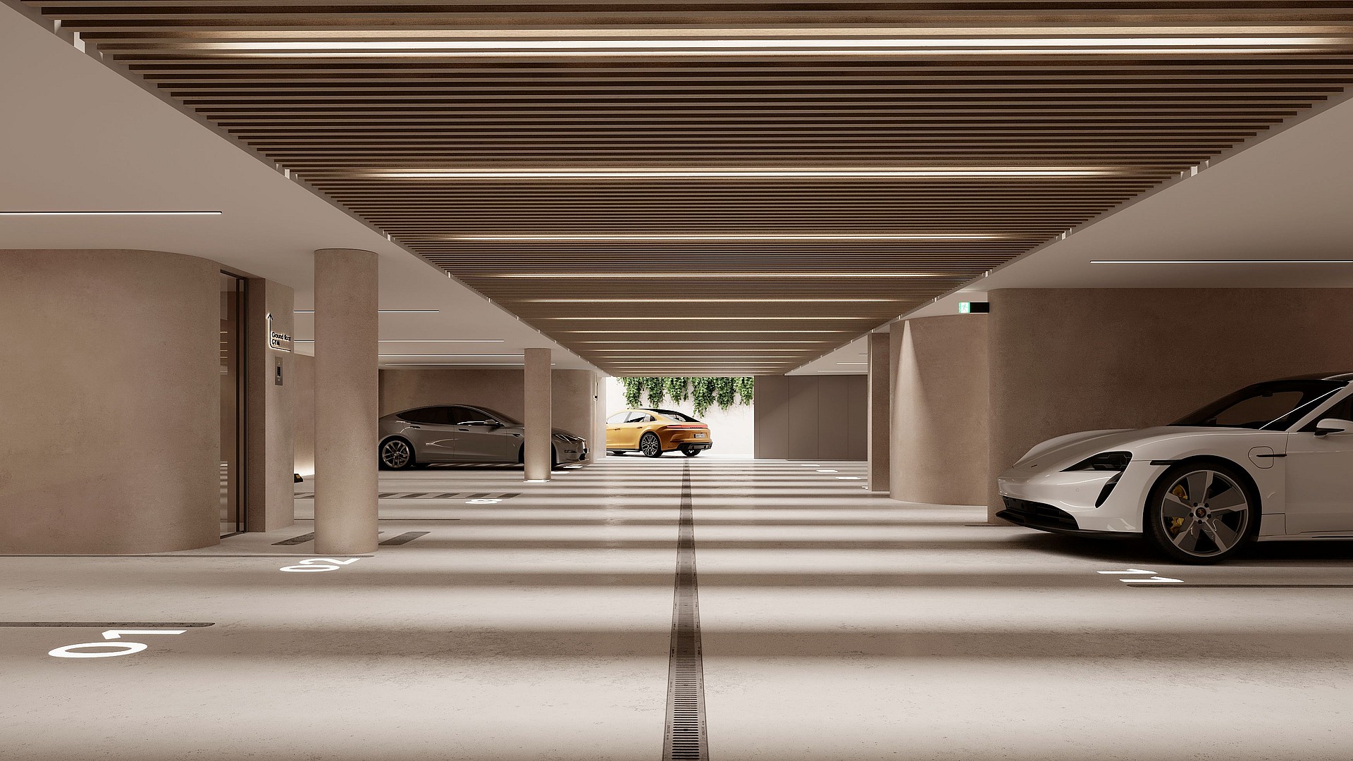 A modern, well-lit subterranean parking garage with concrete columns, linear ceiling lighting, and marked parking spaces.