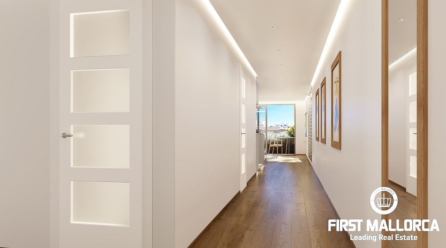 A bright apartment corridor with dark wood flooring, white walls, LED strip lighting, and doors with glass panels.