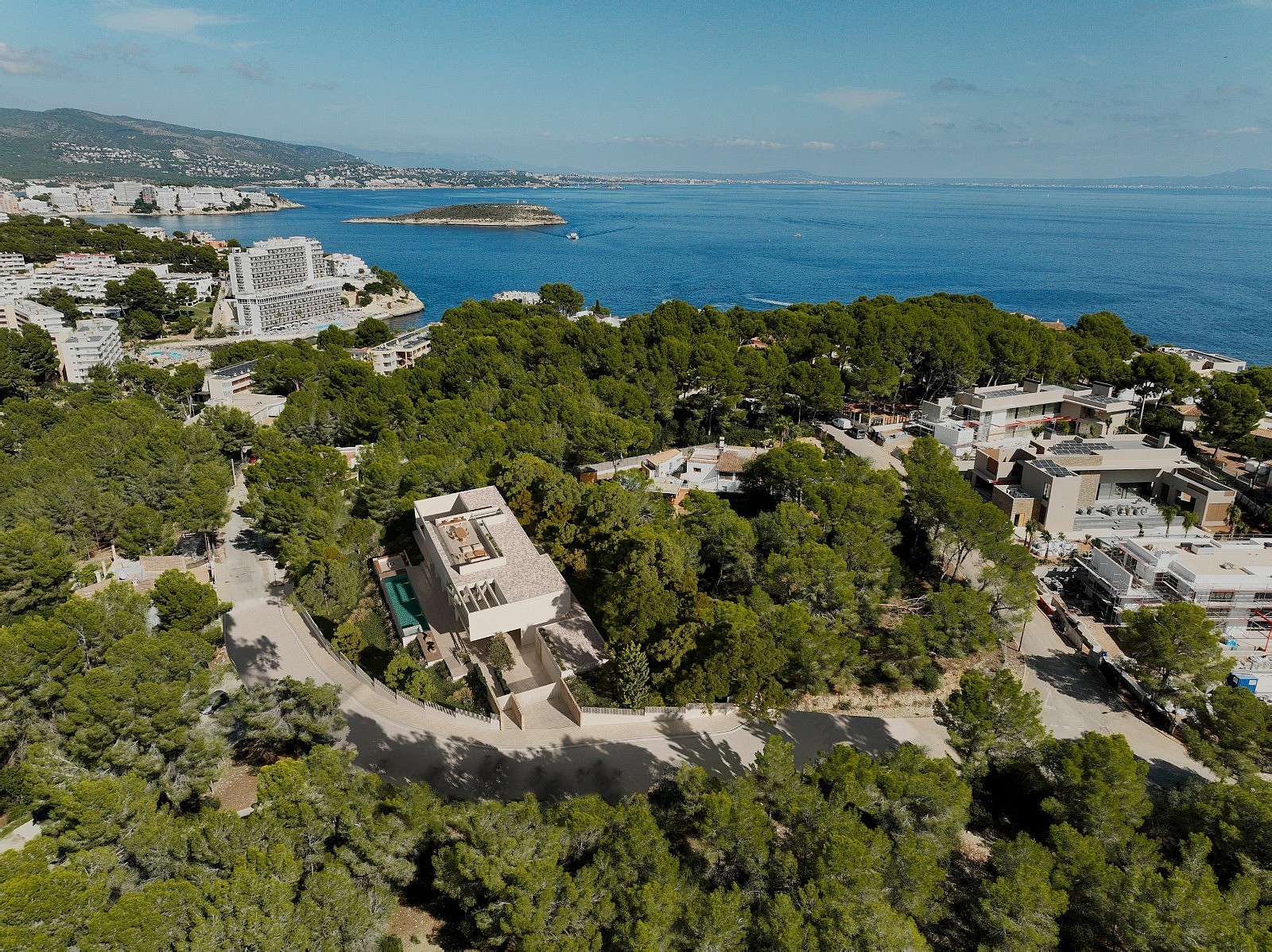 Aerial view of the villa within pine woodland near the coast