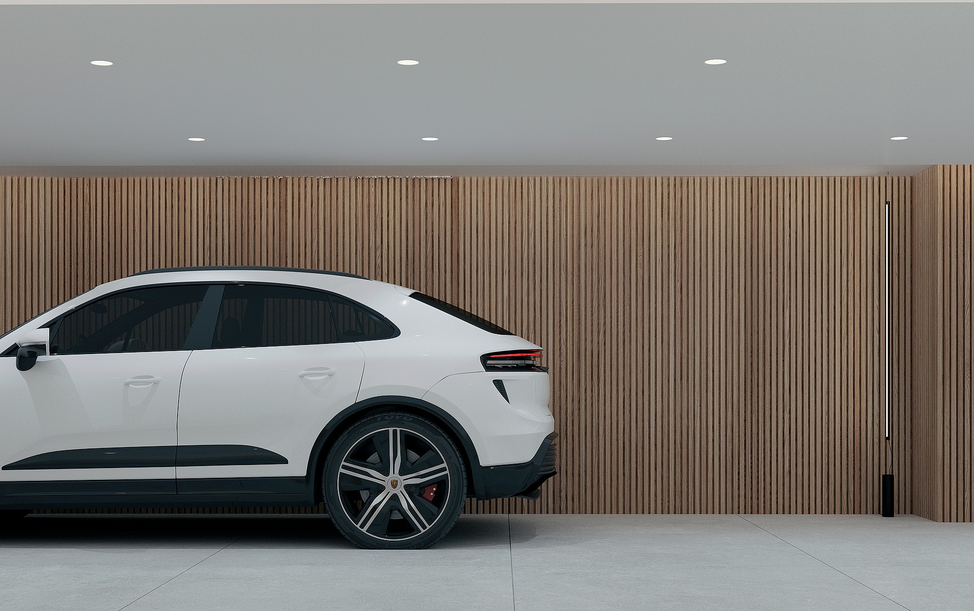 A white car parked in a garage featuring floor-to-ceiling vertical oak wood slats on the back wall and light grey tiled floors.