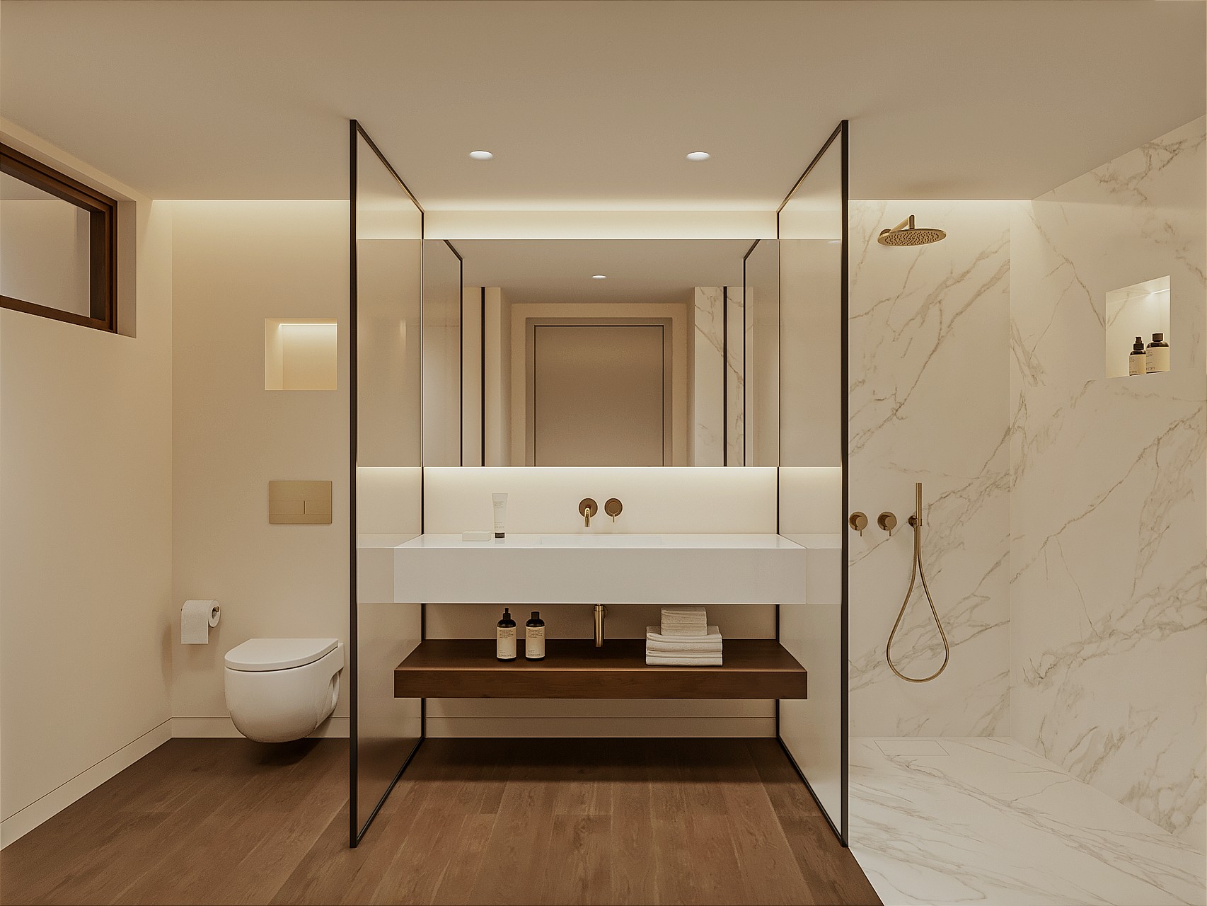 Marble en-suite bathroom with walk-in shower, brushed brass fixtures, wall-hung WC, floating basin on a timber shelf and a backlit mirror.