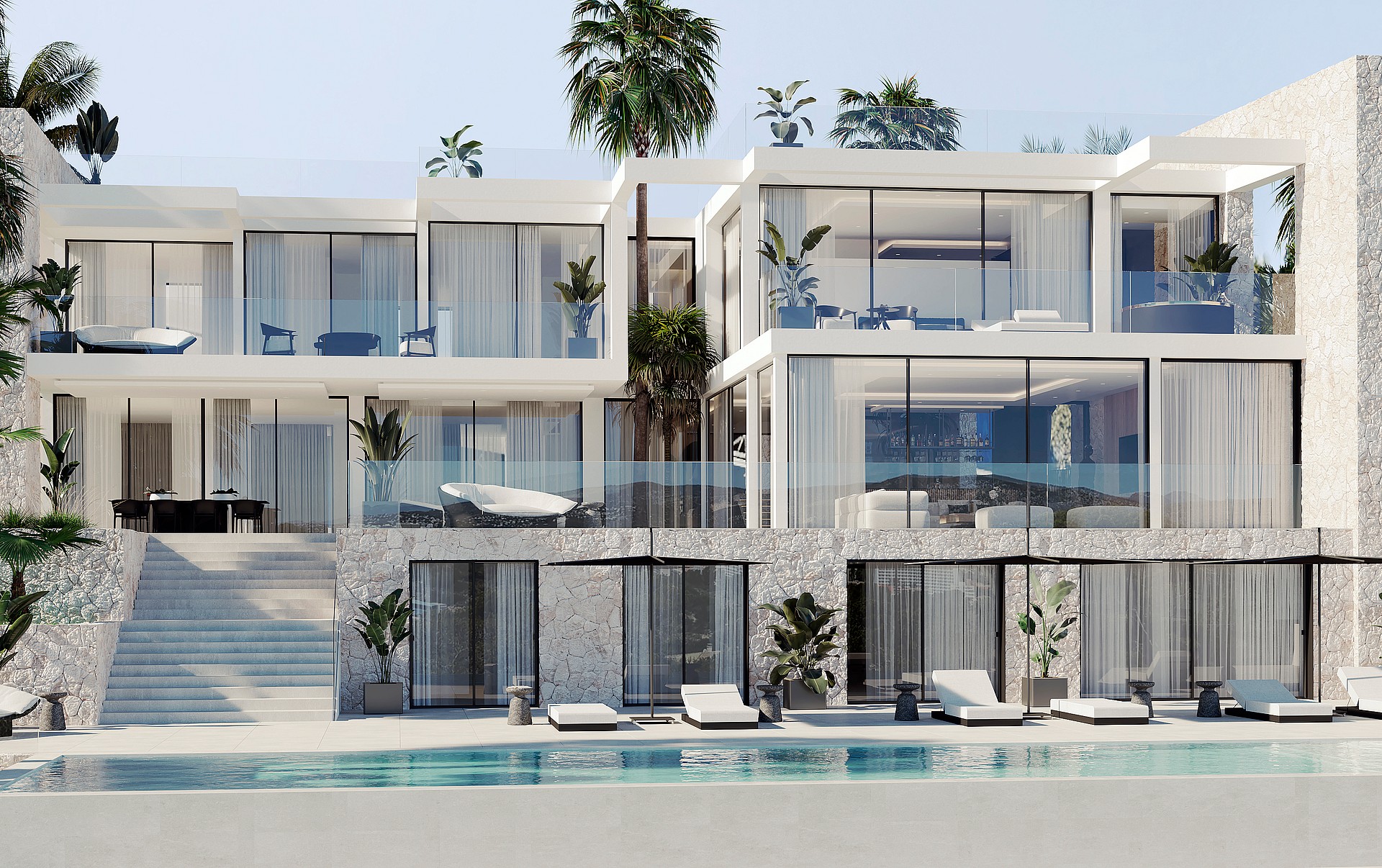 Exterior view of a multi-level contemporary villa with floor-to-ceiling glass windows, a stone-clad lower level, and an outdoor swimming pool with lounge chairs.