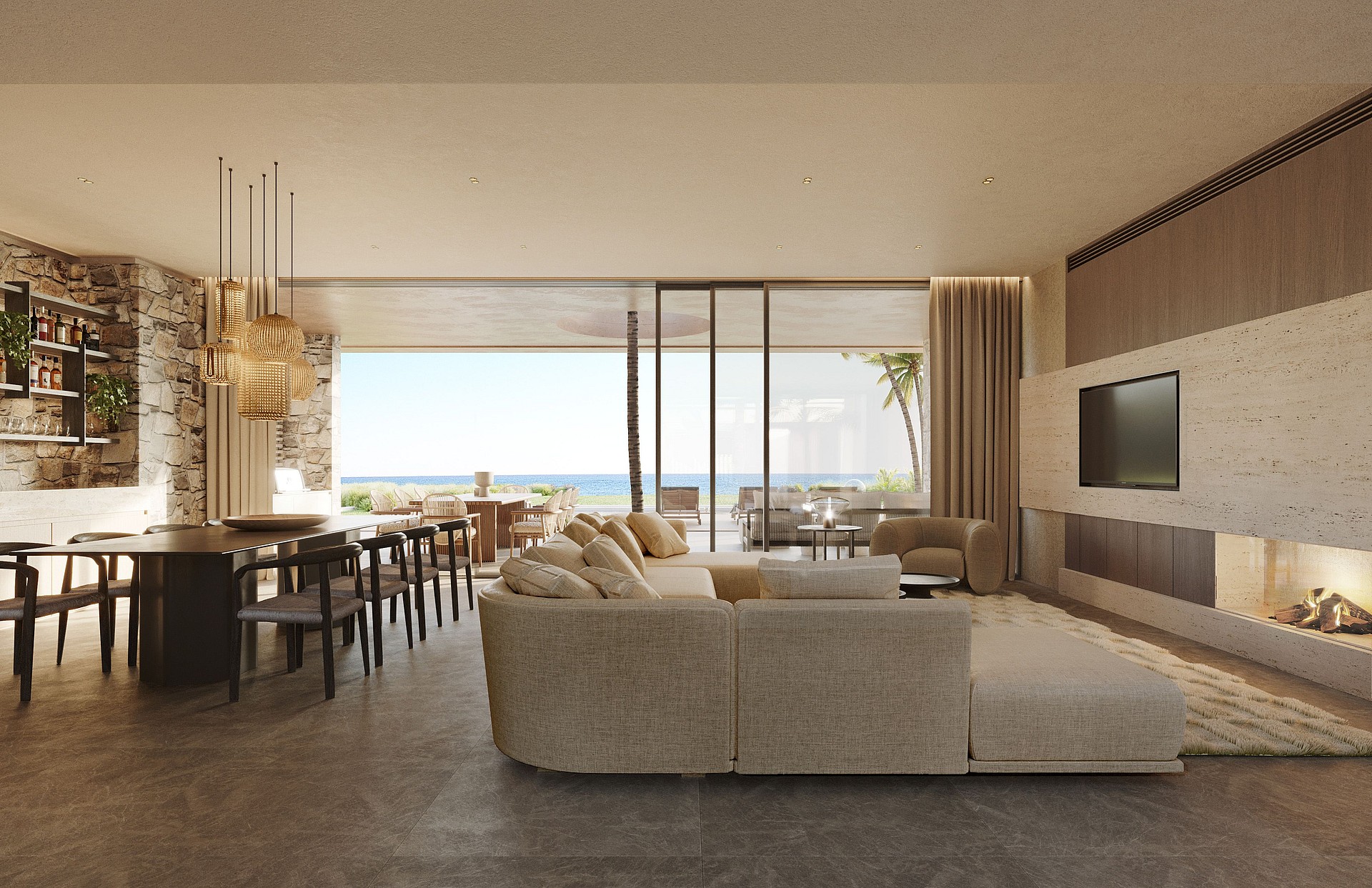 Wide-angle shot of a bright, open-plan living and dining room with floor-to-ceiling glass walls leading to an outdoor terrace, limestone fireplace, and Mediterranean sea views.