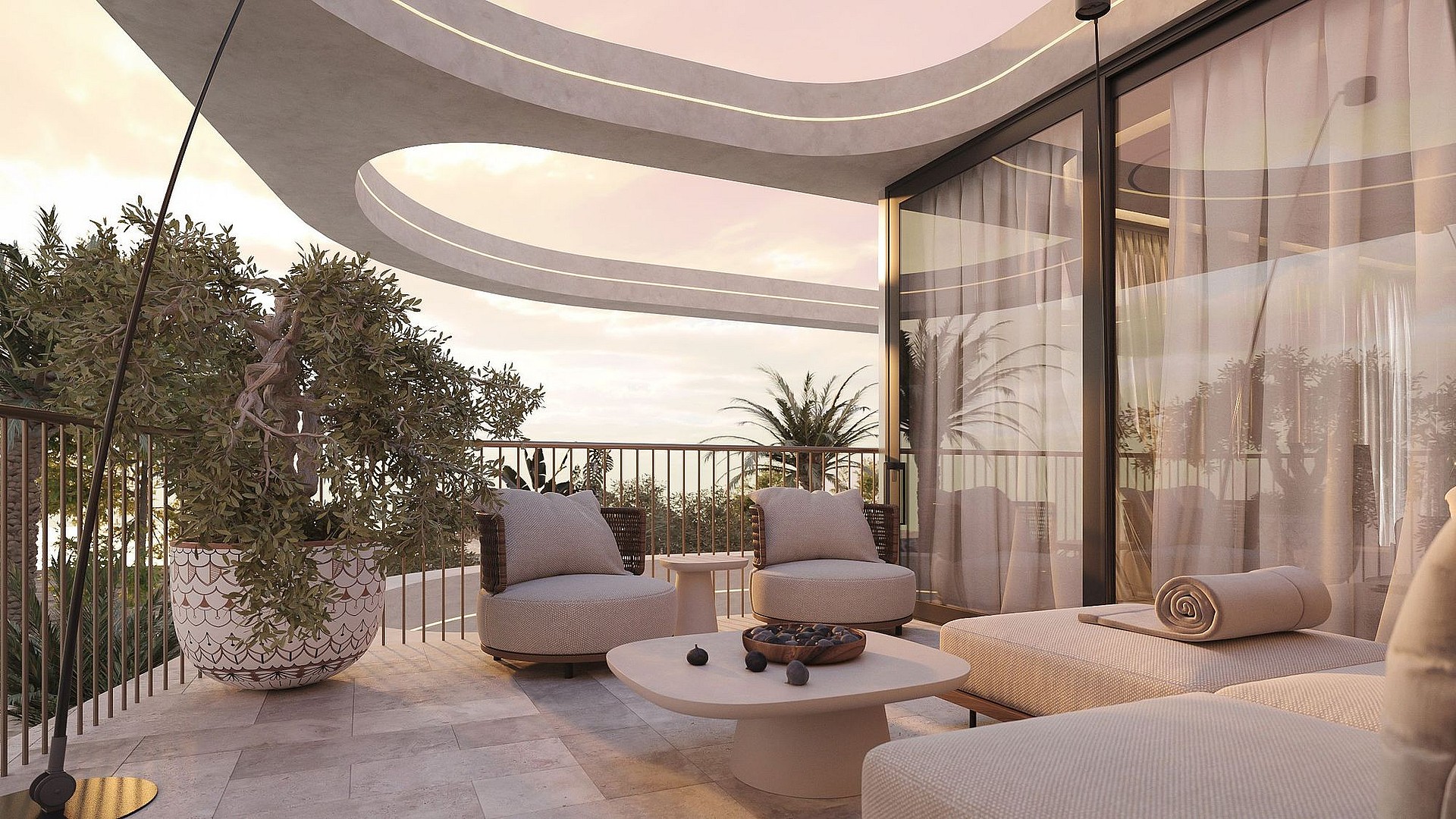 A modern curved terrace overlooking the sea at sunset, featuring stone flooring, outdoor seating, and a large potted plant.