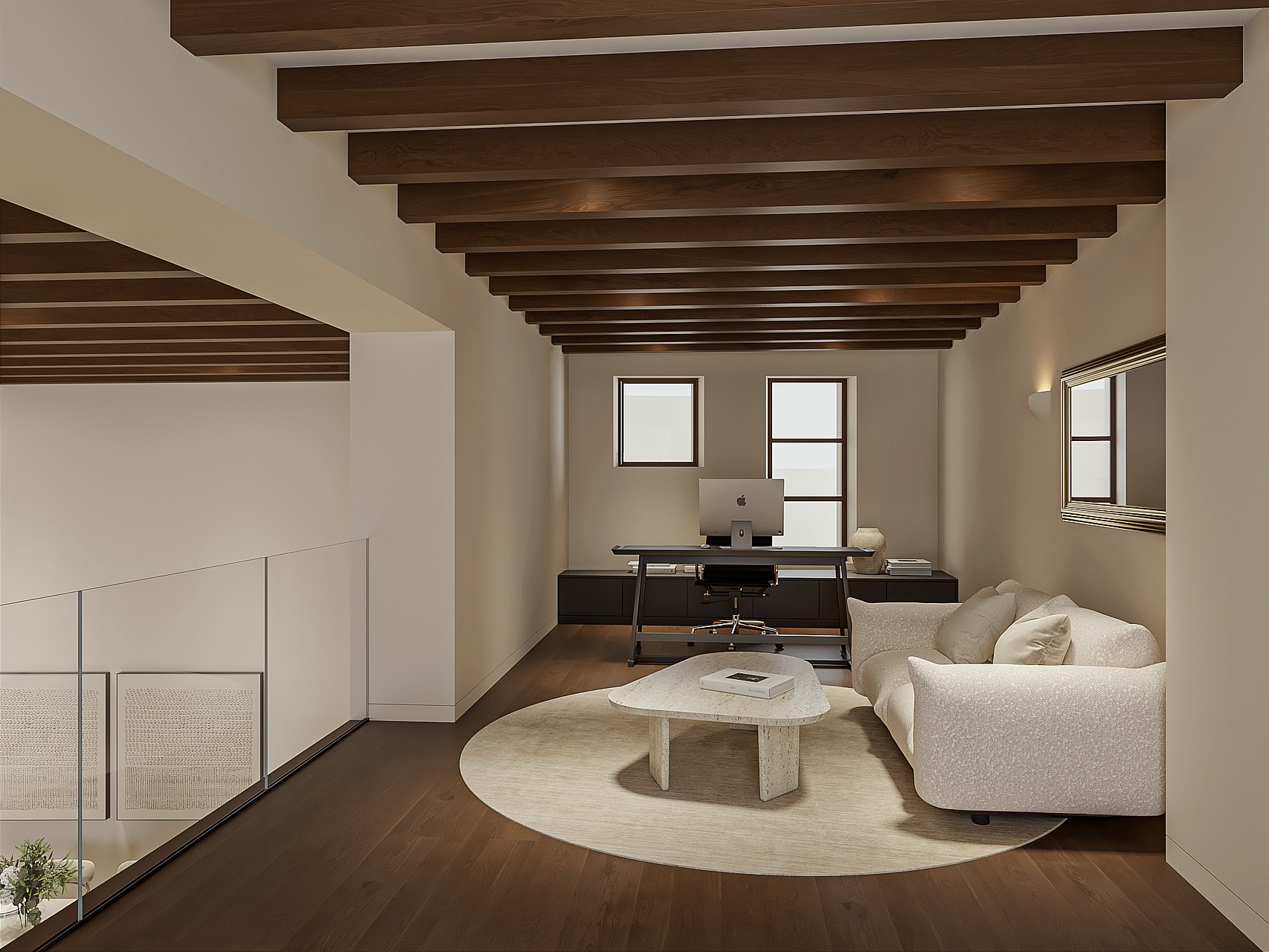 Mezzanine used as a home office with desk and sofa, glass balustrade and exposed dark timber beams overlooking the level below.