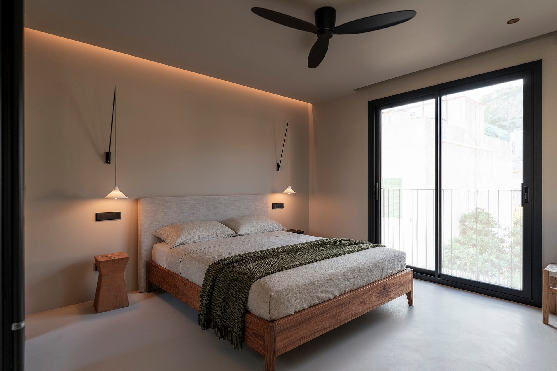 Minimalist bedroom featuring a wooden bed frame, floor-to-ceiling glass doors, and recessed ceiling lighting.