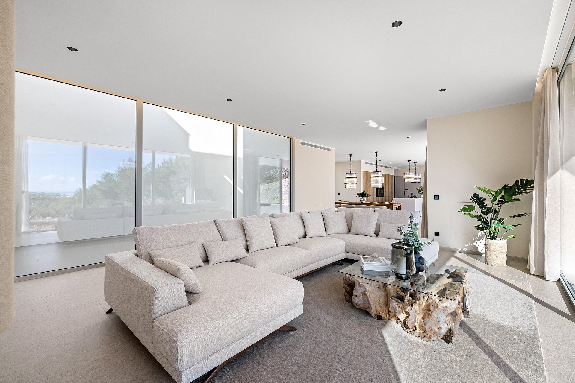 Open-plan living room opening directly to the pool terrace via retractable glazing