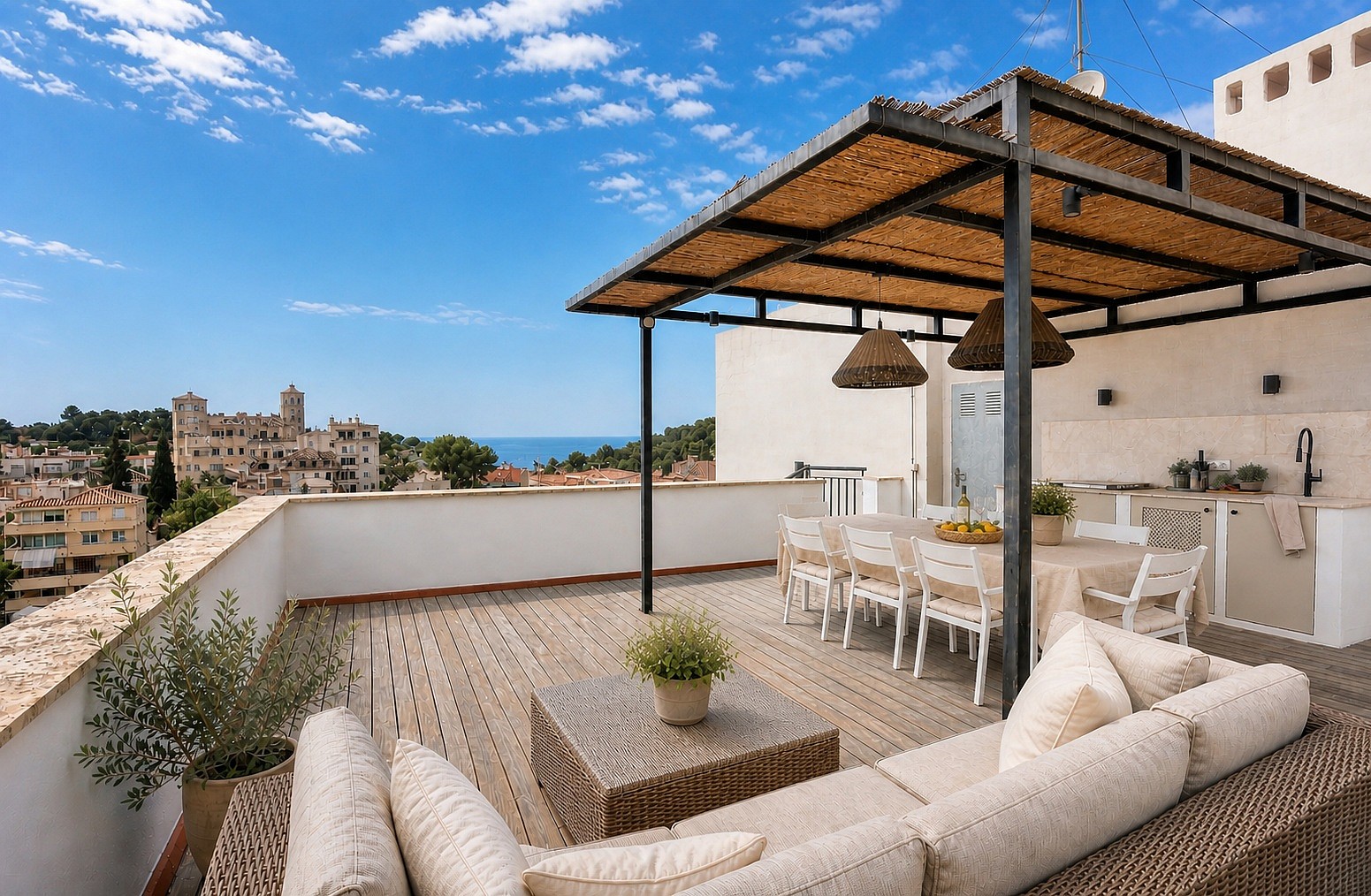 A spacious terrace in San Agustin with a shaded dining area, woven rattan sofa, and a stone-built outdoor kitchen.