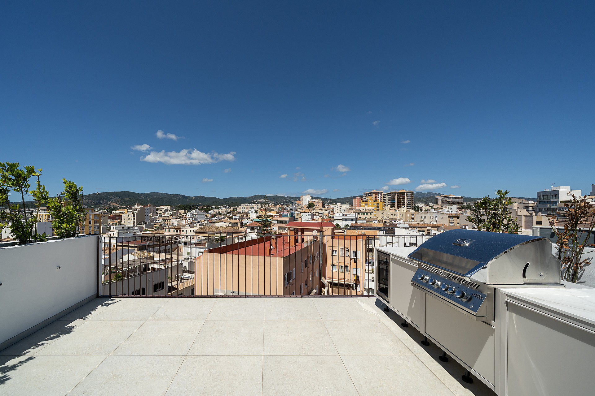 Private rooftop terrace featuring a stainless steel grill, overlooking the cityscape of Santa Catalina.