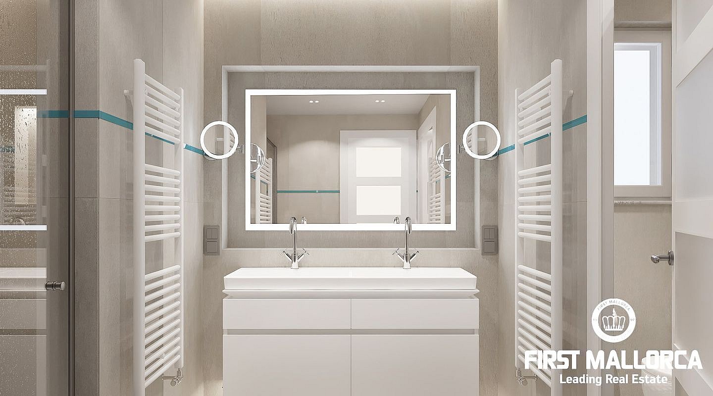 A modern bathroom featuring a white double vanity, large rectangular mirror with integrated lighting, and white heated towel rails against neutral stone-tiled walls.