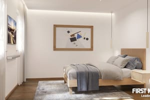 Modern bedroom featuring a wooden bed frame, slatted headboard, plush grey rug, and minimalist lighting against white walls.