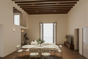Double-height living and dining room with travertine table, pale sofa, exposed beams, tall balcony doors and an internal mezzanine window high on the wall.