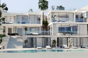 Exterior view of a multi-level contemporary villa with floor-to-ceiling glass windows, a stone-clad lower level, and an outdoor swimming pool with lounge chairs.