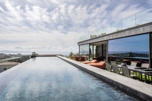 Panoramic view of a sixteen-metre infinity-edge pool overlooking the Bay of Palma, adjacent to a modern terrace.