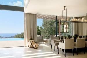 Open-plan living and dining room with natural-toned furnishings and large glazing