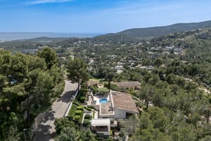 Elevated view from Son Vida villa across green pine-covered hillside toward Palma Bay and the Mediterranean