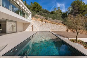 Two-storey contemporary villa with full-width floor-to-ceiling glass overlooking terraced gardens