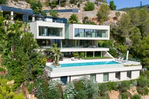 Exterior view of a multi-level contemporary villa in Son Vida, featuring a rectangular infinity pool and terraced levels.