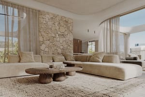 Modern living room with a large beige sectional sofa, a carved wood coffee table, and a feature wall made of round stone logs.