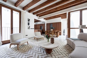 Original Mallorquín floor tiles, exposed beams and double balconies open the lower level to the rhythm of the street.