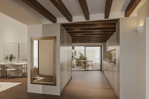 Open-plan kitchen with pale bespoke cabinetry and marble splashback beside a dining table, glazed doors to an interior terrace, exposed timber beams overhead.