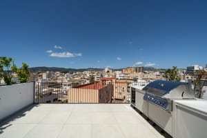Private rooftop terrace featuring a stainless steel grill, overlooking the cityscape of Santa Catalina.