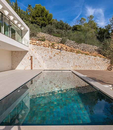 Two-storey contemporary villa with full-width floor-to-ceiling glass overlooking terraced gardens