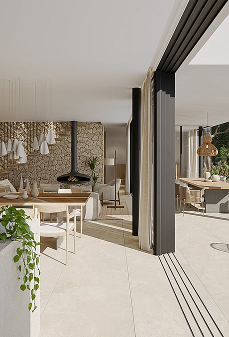 An open-plan kitchen and dining area with stone walls and sliding glass doors leading to a terrace with mountain views.