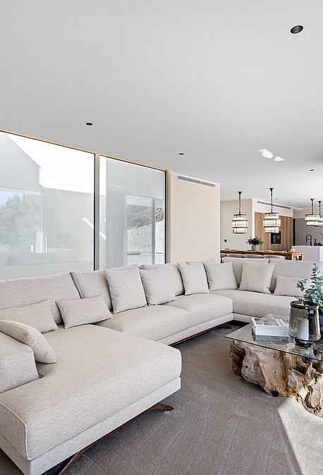 Open-plan living room opening directly to the pool terrace via retractable glazing