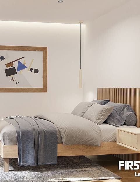 Modern bedroom featuring a wooden bed frame, slatted headboard, plush grey rug, and minimalist lighting against white walls.
