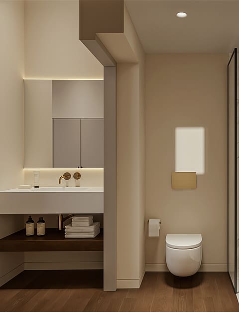 Marble en-suite bathroom with walk-in shower, brushed brass fittings, wall-hung WC and a floating basin under a backlit mirror.