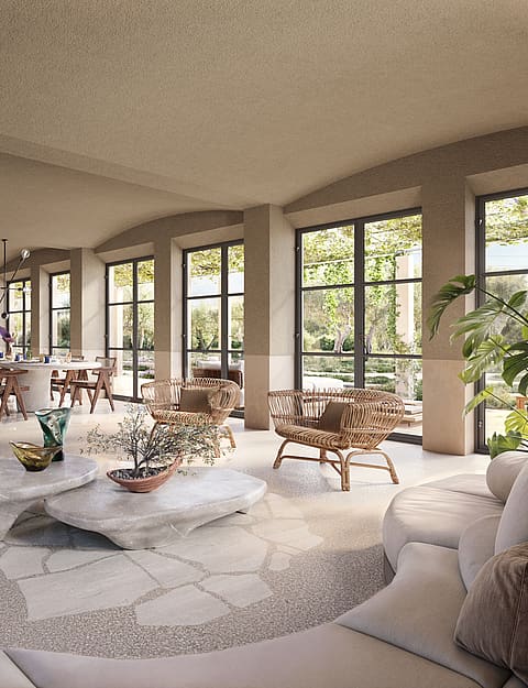 Spacious living and dining room with arched walls, light stone floors, neutral upholstered sofas, and large glass doors.