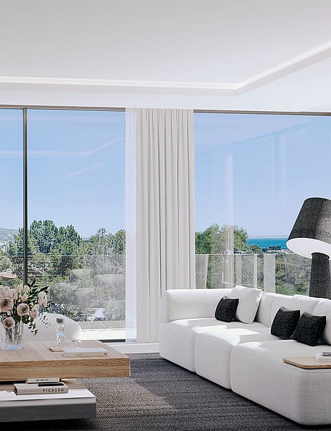 Contemporary living room featuring a white modular sofa, natural wood coffee table, and large glass windows overlooking a landscape.