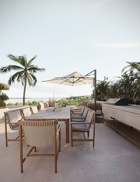 Rooftop terrace with a long outdoor dining table, woven chairs, a cantilever umbrella, and a stone prep area.