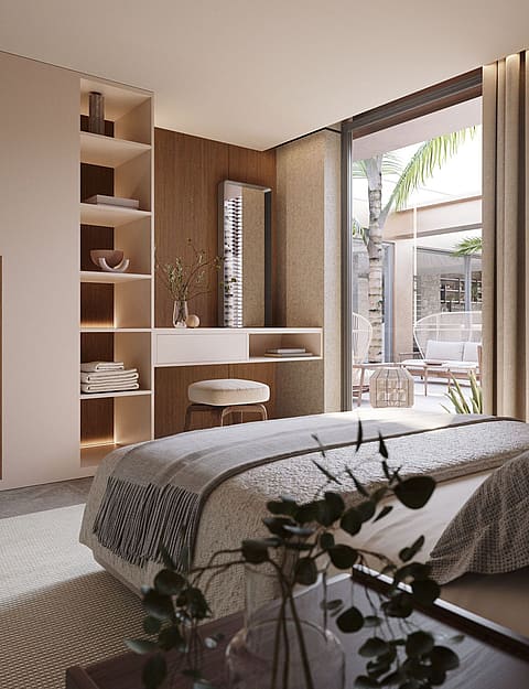 Modern bedroom with light beige built-in wardrobes, a floating vanity desk, and a view through glass doors to a terrace.