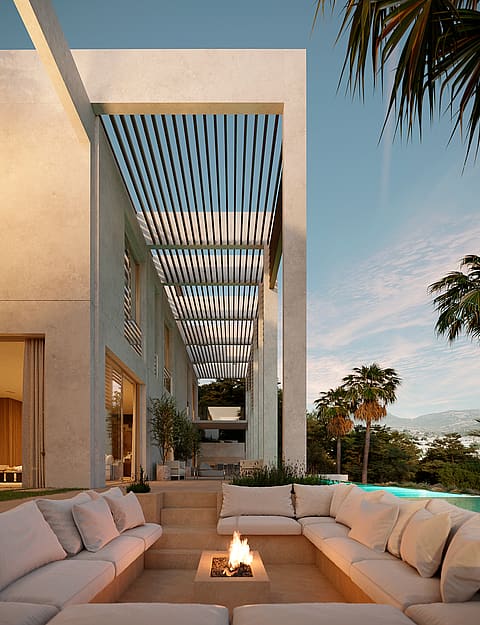Modern villa exterior with a slatted pergola walkway, sunken fire pit lounge, and pool overlooking distant mountains.