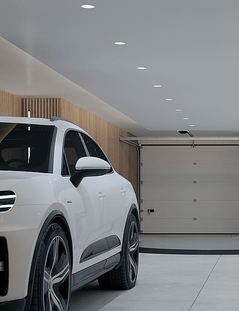 A modern, minimalist private indoor garage featuring a white car parked on a circular rotating platform with light wood slat wall paneling.