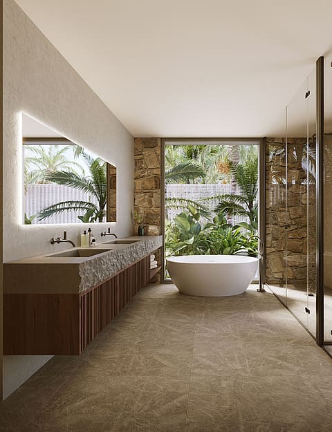 Modern master bathroom featuring a white freestanding bathtub, long stone vanity, and a large window looking onto a green garden.