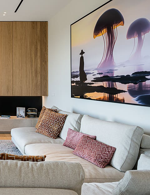 Modern living room featuring a vertical oak slat wall, integrated flat-screen TV, low stone media console, and light-toned sofa.