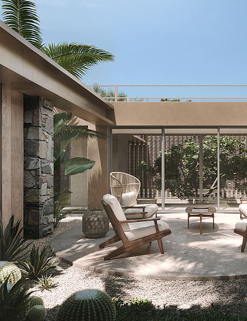 A modern central courtyard featuring a gravel ground, four wooden lounge chairs, and desert-inspired landscaping.