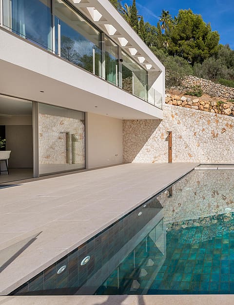 Two-storey contemporary villa with full-width floor-to-ceiling glass overlooking terraced gardens