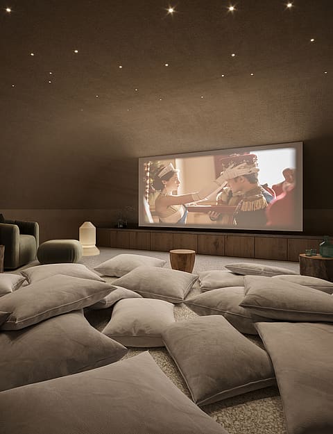 A cozy home theater with a curved vaulted ceiling, recessed spotlights, and numerous floor cushions for seating.