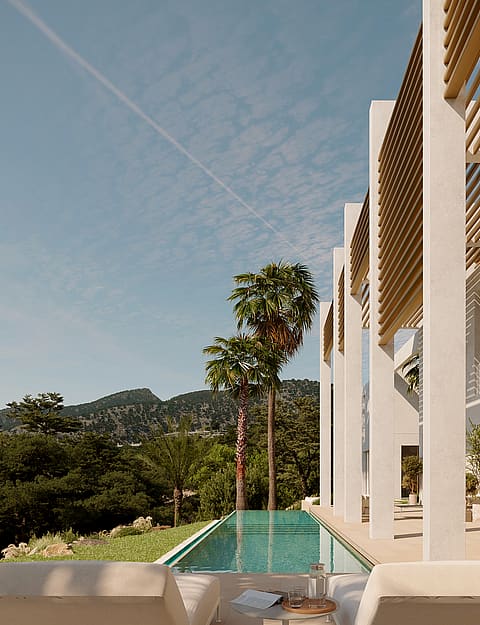 Rectangular turquoise lap pool beside a white modern villa with wooden pergolas, palm trees, and mountain views.